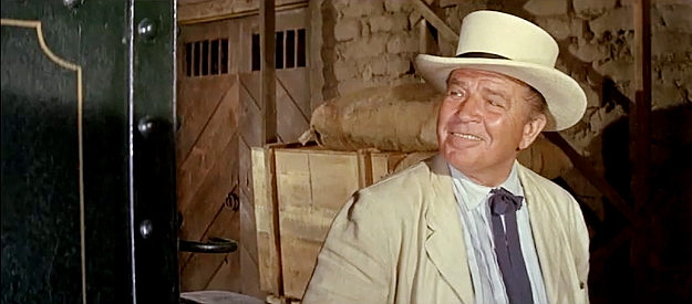 Bruce Cabot as Frank Pierce, admiring the war wagon he relies on to keep his gold shipments safe in The War Wagon (1967)