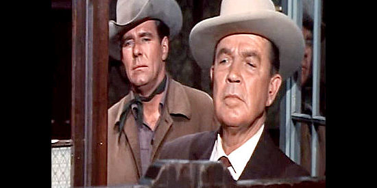 Bruce Cabot as Riley Condor and Philip Carey as Jim Akins watch vigilantes prepare to storm the saloon in Town Tamer (1965)