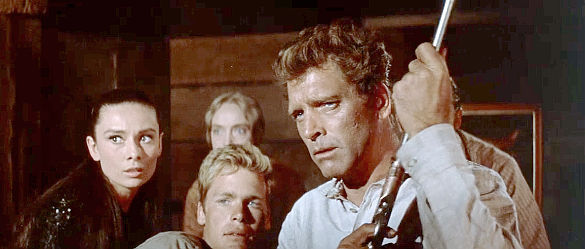 Burt Lancaster as Ben Zachary, preparing for a confrontation with Rachel (Audrey Hepburn) and Andy (Doug McClure) by his side in The Unforgiven (1960)