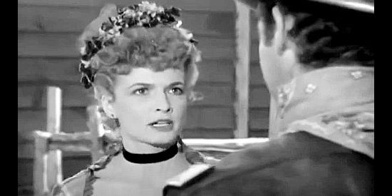 Carole Mathews as Laura Jordan, letting the sparks fly when she finds Larry Knight rummaging through her luggage in Massacre River (1949)