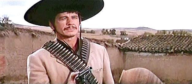 Charles Bronson as Fierro, threatening to gun down yet another man in Villa Rides (1968)