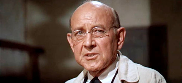 Charles Seel as Dr. Walter Eckner, testifying about his findings at the scene of the rape and murders in Sergeant Rutledge (1960)