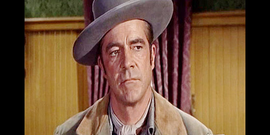 Dana Andrews as Johnny Reno, trying to get to the bottom of a mystery in Stone Junction in Johnny Reno (1966)