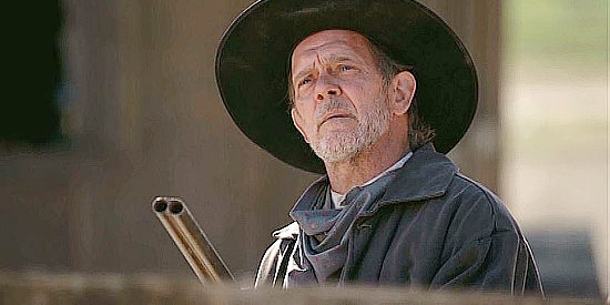 Dave Florek as Baldy, one of Ray Eastman's loyal ranch hands in Shadow on the Mesa (2013)