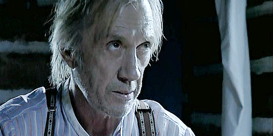 David Carradine as Dr. Lucas Henry, trying to mend Johnny Gault's wounds in The Outsider (2002)