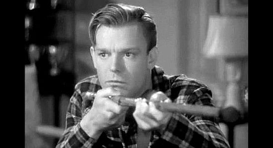 Dennis O'Keefe as William Quincy 'Wild Bill' Malone, telling tall tales about his days as an Indian fighter in The Kid from Texas (1939)