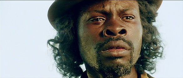 Djimon Hounsou as Woodhead, searching for gold in Indian territory in Renegade (2004)