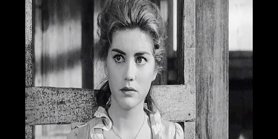 Dolores Hart as Ellie Walters, watching the men of Trail City debate how to deal with the man who attacked her in The Plunderers (1960)