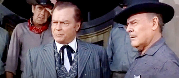 Don 'Red' Barry as Ed Johnson and Brian Donlevy as Marshal Willett, dealing with a ill-tempered gambler in Hostile Guns (1967)