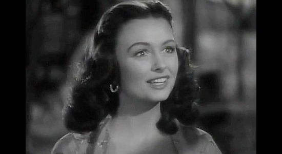 Donna Reed as Rosalia Martinez, the senorita in love with Tom Folliard in Apache Trail (1942)