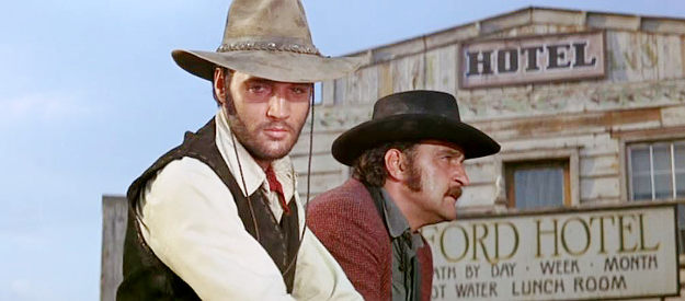 Elvis Presley as Jess Wade, treated to an unwelcome reunion with former outlaw buddy Vince Hackett (Victor French) in Charro! (1969)