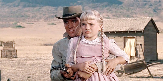 Elvis Presley as Pacer using Doc Phillips' daughter Dottie (Barbara Beaird) to coerce the doctor to treat his wounded mother in Flaming Star (1960)