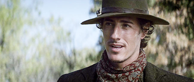 Eric Balour as Will Edwards, a small-town crook on the run in The Legend of Hell's Gate (2011)