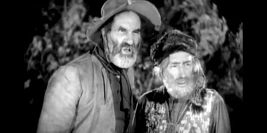 Ernest Torrence as Bill Jackson and Tully Marshall as Jim Bridger, fretting that Clint's become susceptible to a woman's influence in Fighting Caravans (1931)