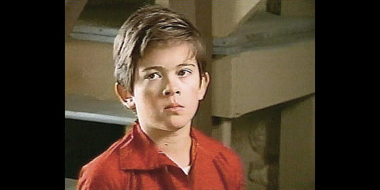 Evan Smith as young Tom Cross, scarred by his father's death in Defiance (2002)