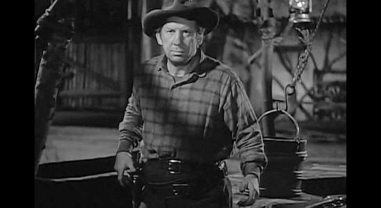 Fuzzy Knight as Juke, surprised to see Trigger Bill wearing six guns again in Apache Trail (1942)
