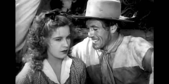 Gary Cooper as Clint Belmet, trying to get to know the pretty French gal named Felice (Lili Damita) better in Fighting Caravans (1931)