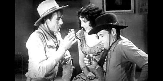 Gary Cooper as the Virginian and Richard Arlen as Steve, fliring with a saloon girl (Nina Quartero) Trampas considers his property in The Virginian (1929)