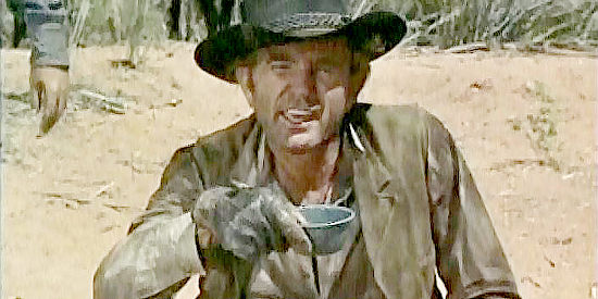 George Wallace as Boone, trying to talk Frank Jesse into swapping fresh horses for tired mounts in Six Black Horses (1962)