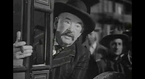 George Watts as Judge Keeley, pronouncing a sentence on Tom Folliard from inside a stagecoach in Apache Trail (1942)