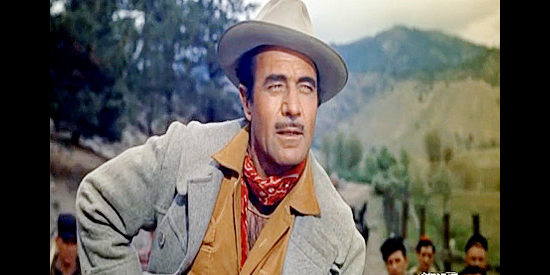Gilbert Roland as Monty Walker, tiring of partner Jim Hadley's patience in dealing with the ranch owners in Guns of the Timberland (1960)