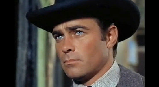 Glenn Corbett as Chance Reynolds, Elizabeth's brother, arriving in Lawrence to learn his father has been killed in This Savage Land (1969)