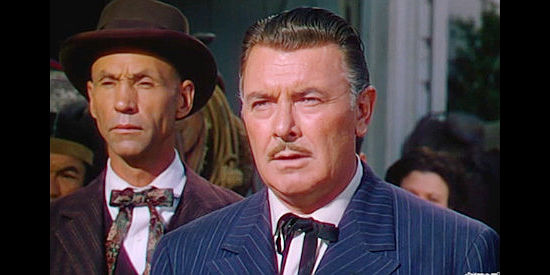 Hank Warden as Charlie and George Brent at Matthew Bostel, dealing with a stranger at Lucy's birthday party in Red Canyon (1949)