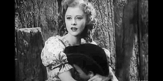 Heather Angel as Virginia Randolph, trying to console her brother Jerry as Daniel heads off on a dangerous journey in Daniel Boone (1936)