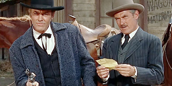 Herbert Rudley as Perrick (right), reading a letter Clay Santell claims will clear him in Hell Bent for Leather (1960)