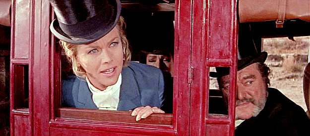 Honor Blackman as Julia Daggett, insisting someone keep an eye out for the countess as her husband Charles (Jack Hawkins) looks on in Shalako (1968)