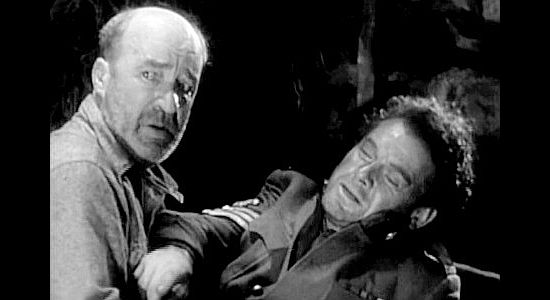 J. Farrell MacDonald as Pat O'Toole with a badly ailing Sgt. Conniston (Charles Bickford) in River's End (1930)