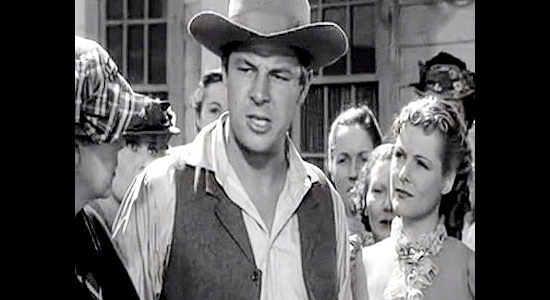 Jack Carson as Jack Tyndall, reacting to Destry's treatment of the Claggett family while his sister Janice (Irene Hervey) looks on in Destry Rides Again (1939)