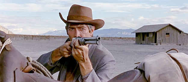James Coburn as Lewton Cole, in an unconventional gunfight with Doc Quinlen in Waterhole #3 (1967)