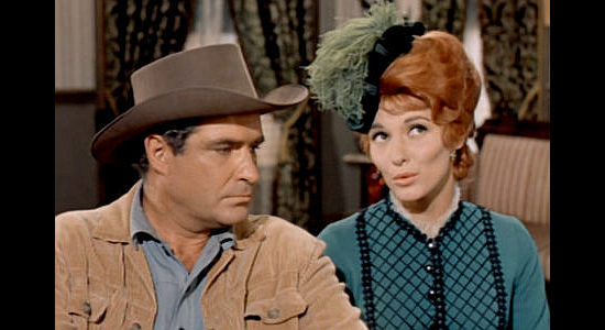 James Philbrook as Marshal Jim McDowell, stood up and listening to a possible solution from Rose Sharon (Nancy Kovack) in The Wild Westerners (1962)