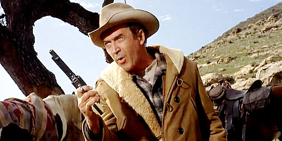 James Stewart as Guthrie McCabe, making a point with his six-gun in Two Rode Together (1961)