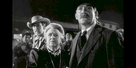 Jane Darwell as Kate Nelson and Roy Roberts as Tombstone's mayor, watching Wyatt Earp head into a saloon to deal with a rowdy drunk in My Darling Clementine (1946)
