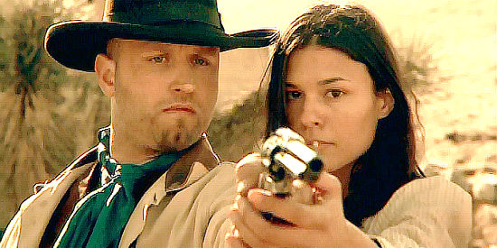 Jarret LeMaster as Nate, getting lessons in shooting left-handed from Em (Michelle Acuna) in Bounty (2009).jpg