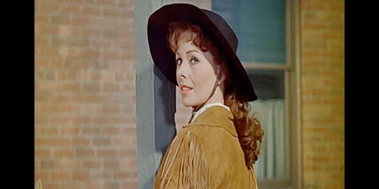 Jeanne Crain as Laura Riley, prepared to give Jim Hadley a history lesson in what happens to a town after loggers leave in Guns of the Timberland (1960)