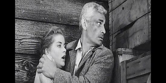 Jeff Chandler as Sam Christy, protecting Ellie (Dolores Hart) from a rampaging Rondo in The Plunderers (1960)