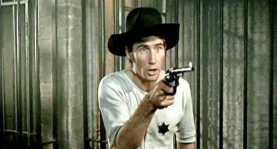 Jim Dale as Marshal P. Knutt, unsteady with his pistol as he tries to lock up The Rumpo Kid gang in Carry on Cowboy (1966)