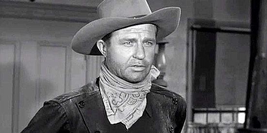 Jim Davis as Case Britton, arriving to warn a town where he isn't welcome in Noose for a Gunman (1960)