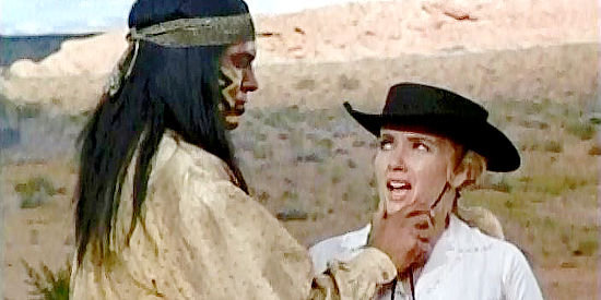 Joan O'Brien as Kelly, undergoing an inspection by an Apache warrior who wants her in exchange for a horse in Six Black Horses (1962)