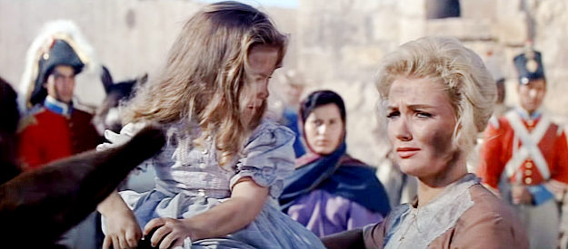 Joan O'Brien as Sue Dickinson, the captain's wife, preparing to leave the mission after the battle in The Alamo (1960)