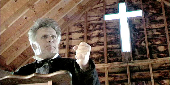 Joe Estevez as the Rev. Hearting, scaring away parishioners with his fiery rhetoric in Gunfight at Yuma (2012)