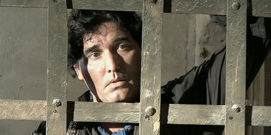 John Castellanos as Johnny Rios, causing unexpected problems for the sheriff even behind bars in Retribution Road (2007)