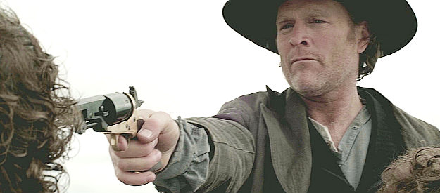 John Freeman as Henry Heath, threatening an outlaw to keep his partner from escaping in Redemption for Robbing the Dead (2011)