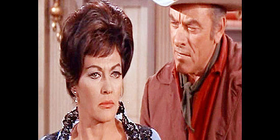 John Ireland as Deputy Dan Shelby, his suspicions aroused by the interest Jill Wyler (Yvonne DeCarlo) shows in the new sheriff in Arizona Bushwhackers (1968)