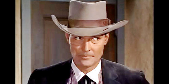 John Russell as Vance Buckner, planning an $80,000 stage holdup in Apache Uprising (1966)
