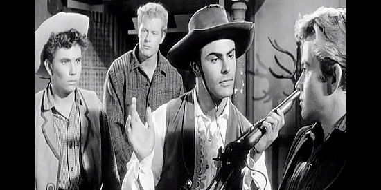 John Saxon as Rondo, holding Sam Christy's shattered rifle while Davy (Dee Pollack), Mule (Roger Torrey) and Jeb (Ray Stricklyn) look on in The Plunderers (1960)