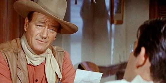 John Wayne as Capt. Jake Cutter, having found Paul Regret, the man he was looking for in The Comancheros (1961)